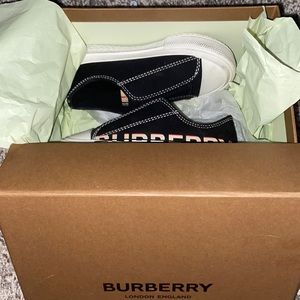 Toddler designer shoes. Black, white, and red.